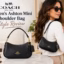 Coach Women's Ashton Mini black leather shoulder bag with gold hardware displayed beside a model wearing it.